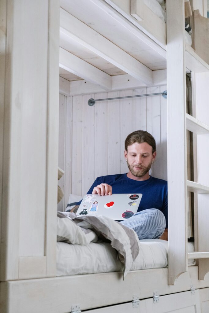 Man Sitting on Bunk Bed